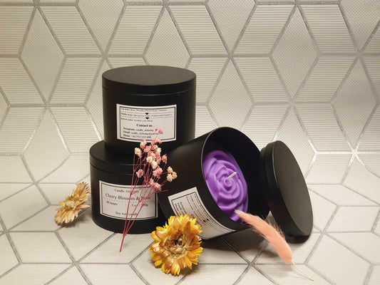 Black handmade tin candle with wax flower decor, perfect for gifts, anniversaries, and party favours.