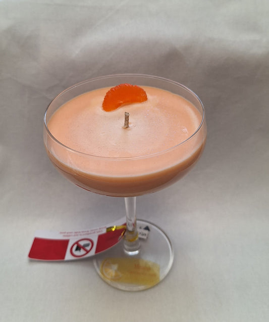 Handmade cocktail glass candle with peach-orange color and fruit garnish and mint leaves, eco soy wax, perfect novelty gift or summer home décor.