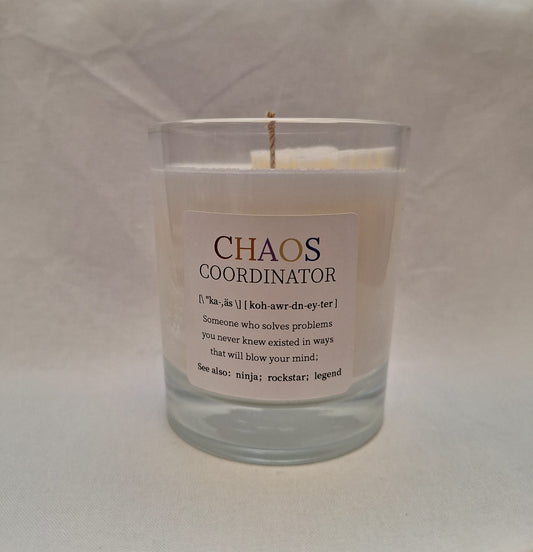 Handmade soy wax candle in glass jar with “Chaos Coordinator” label, fun gift for coworkers or friends, ideal for office décor or stress relief.