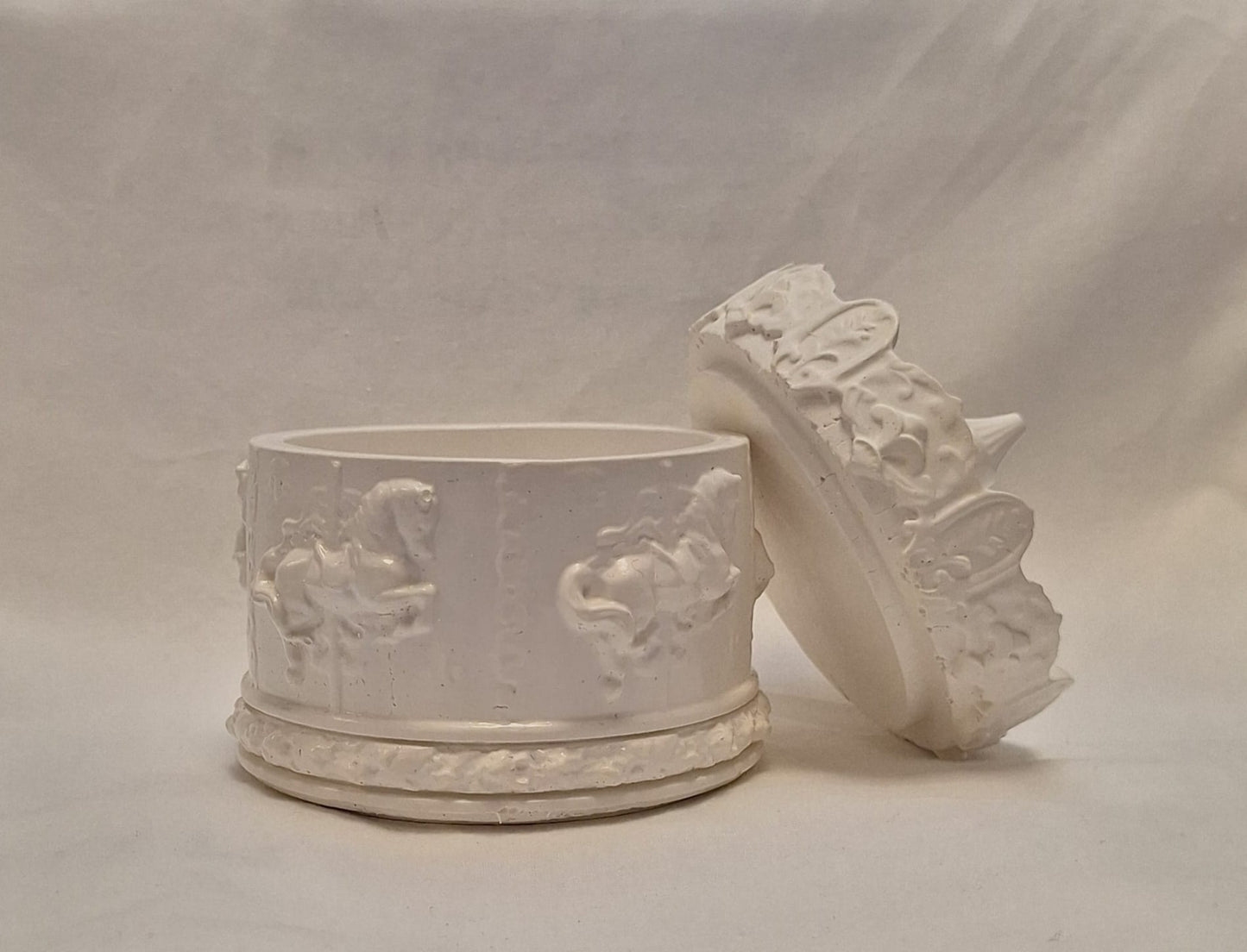 White handmade resin carousel trinket box with horse designs and removable ornate lid.