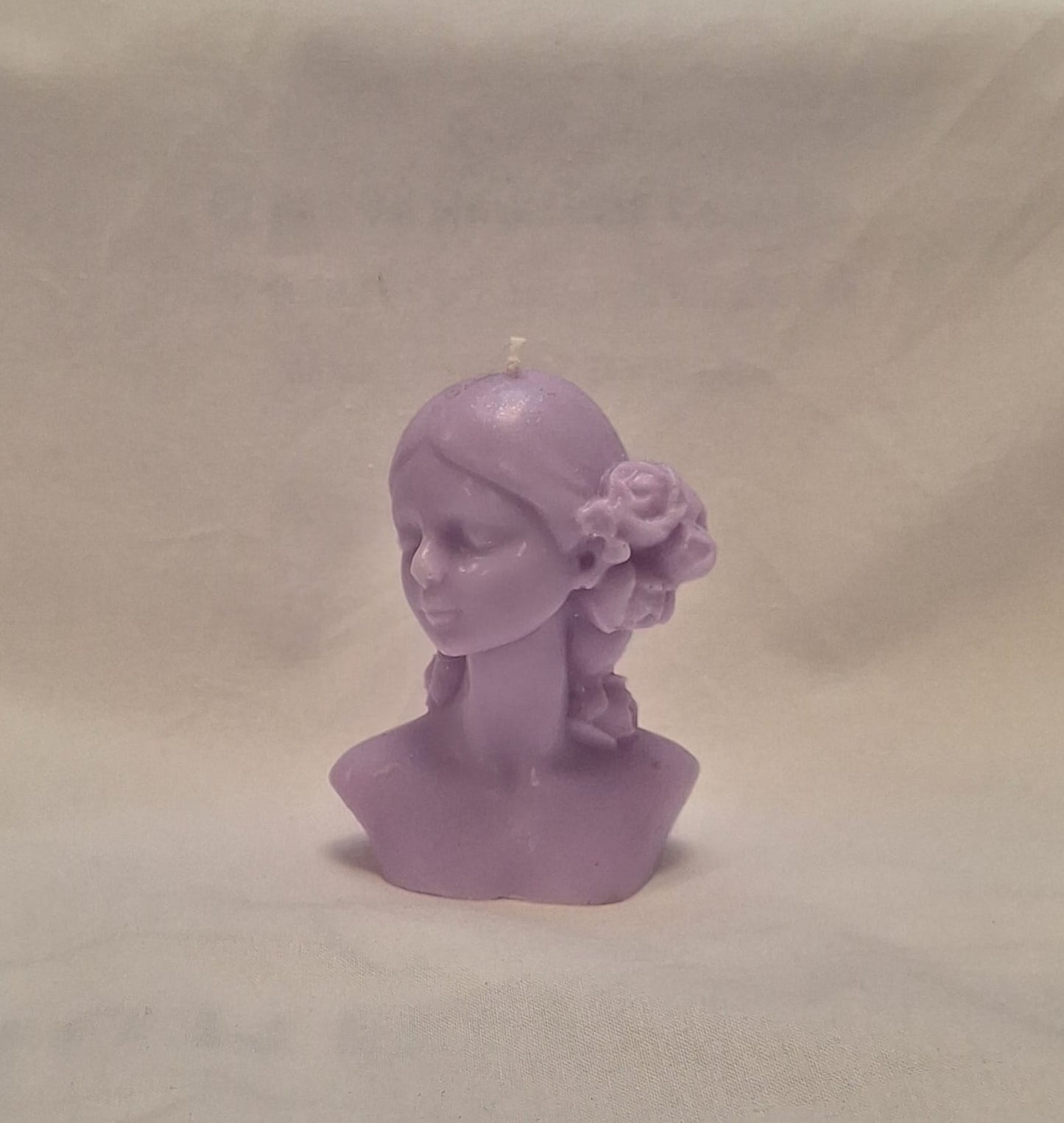 Handmade lavender soy wax girl bust candle with sculpted rose hair detail, perfect for gifts or home decor.