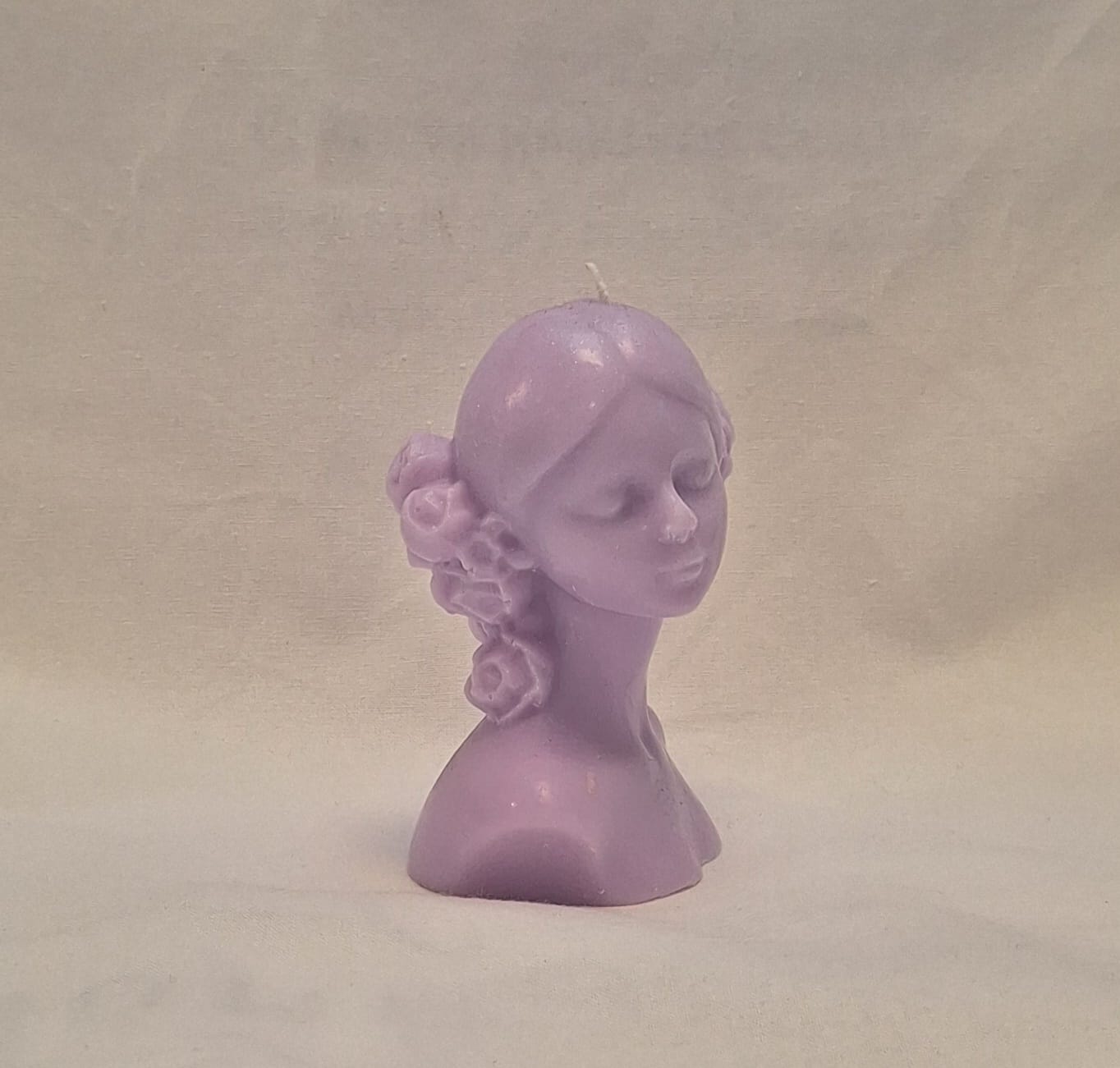 Handmade lavender soy wax girl bust candle with sculpted rose hair detail, perfect for gifts or home decor.