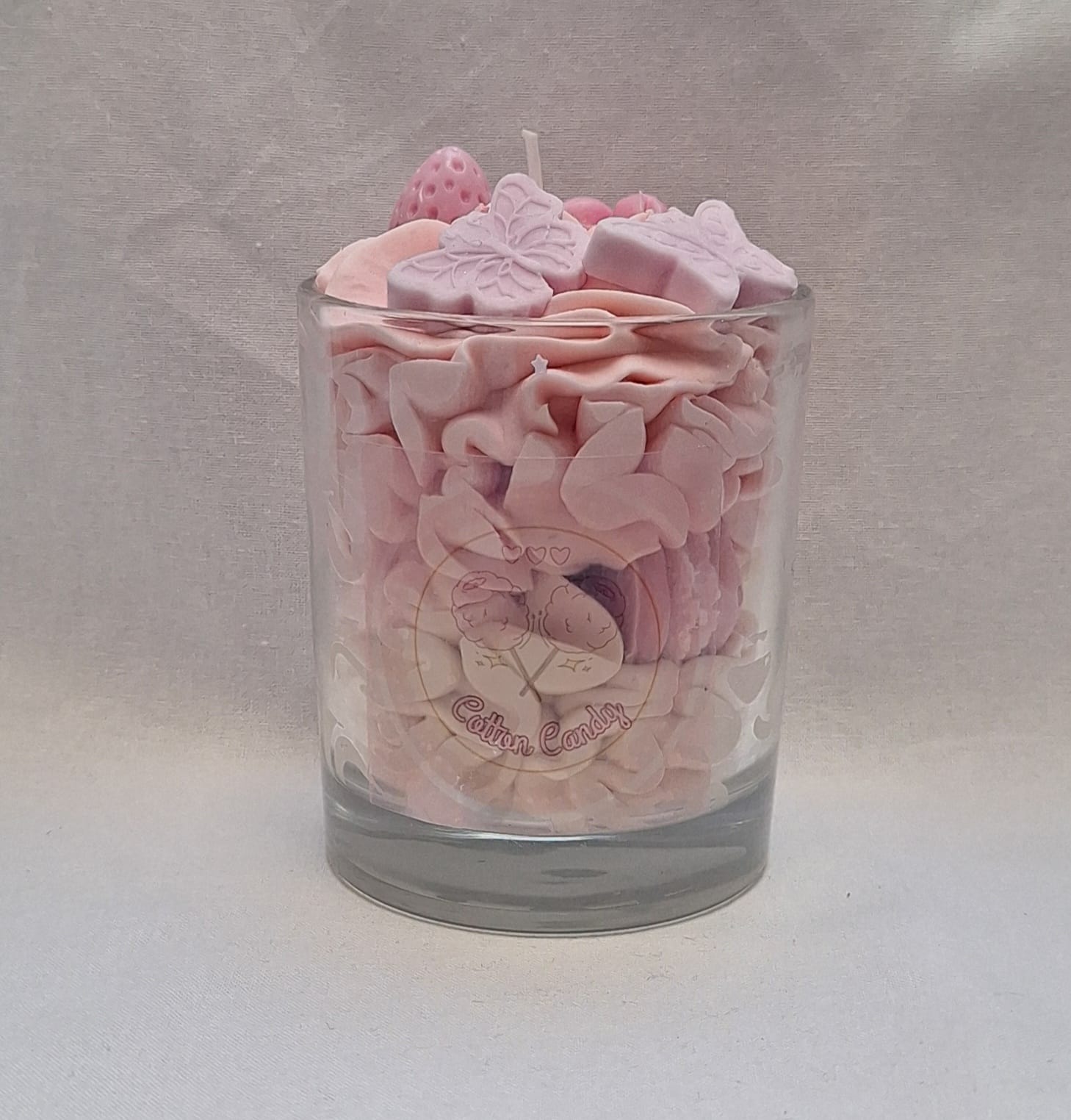 Cotton candy scented candle in clear glass jar, handmade and hand-poured, sweet nostalgic aroma, perfect for birthday gifts or cozy evenings.