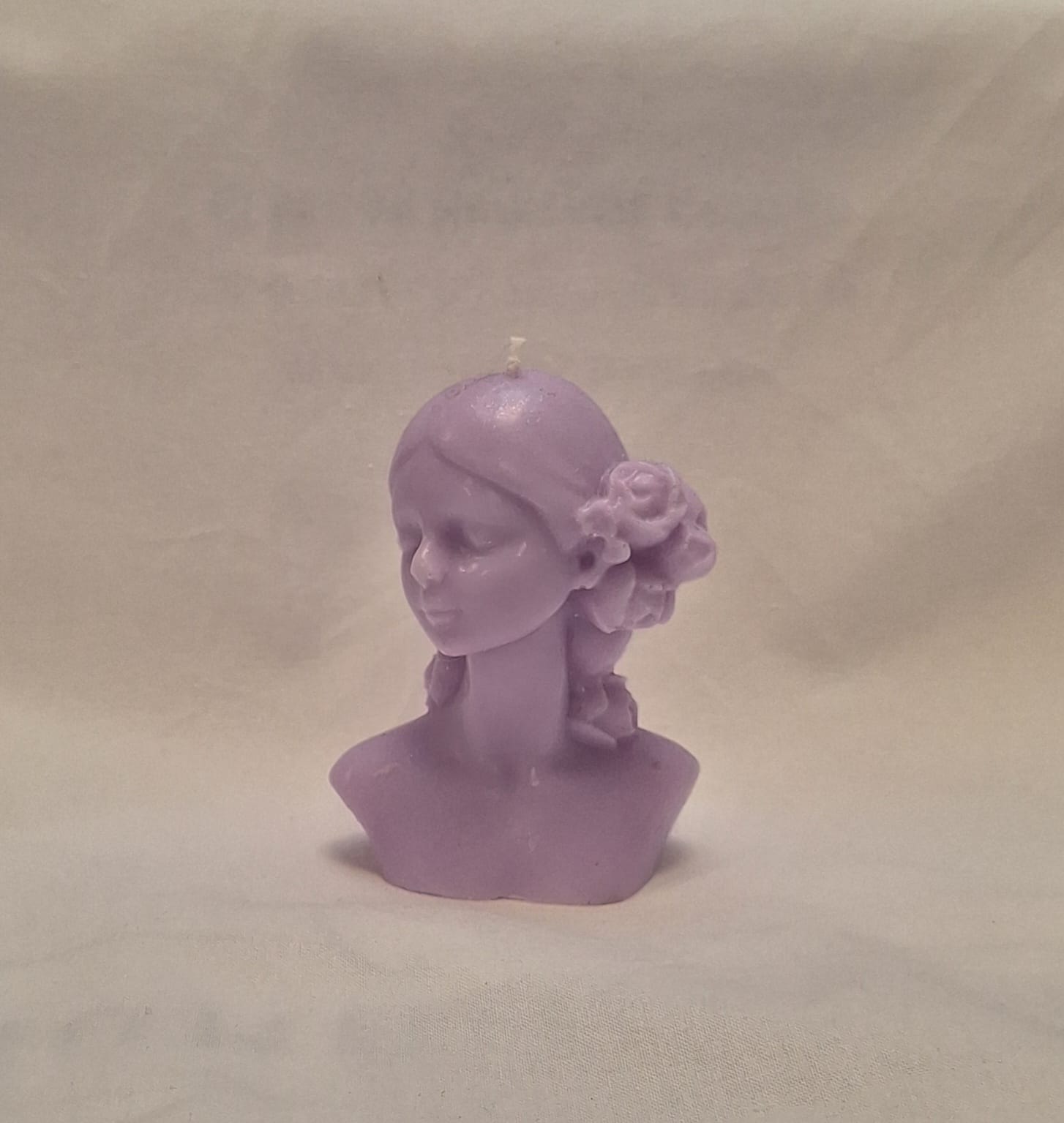 Handmade lavender soy wax girl bust candle with sculpted rose hair detail, perfect for gifts or home decor.