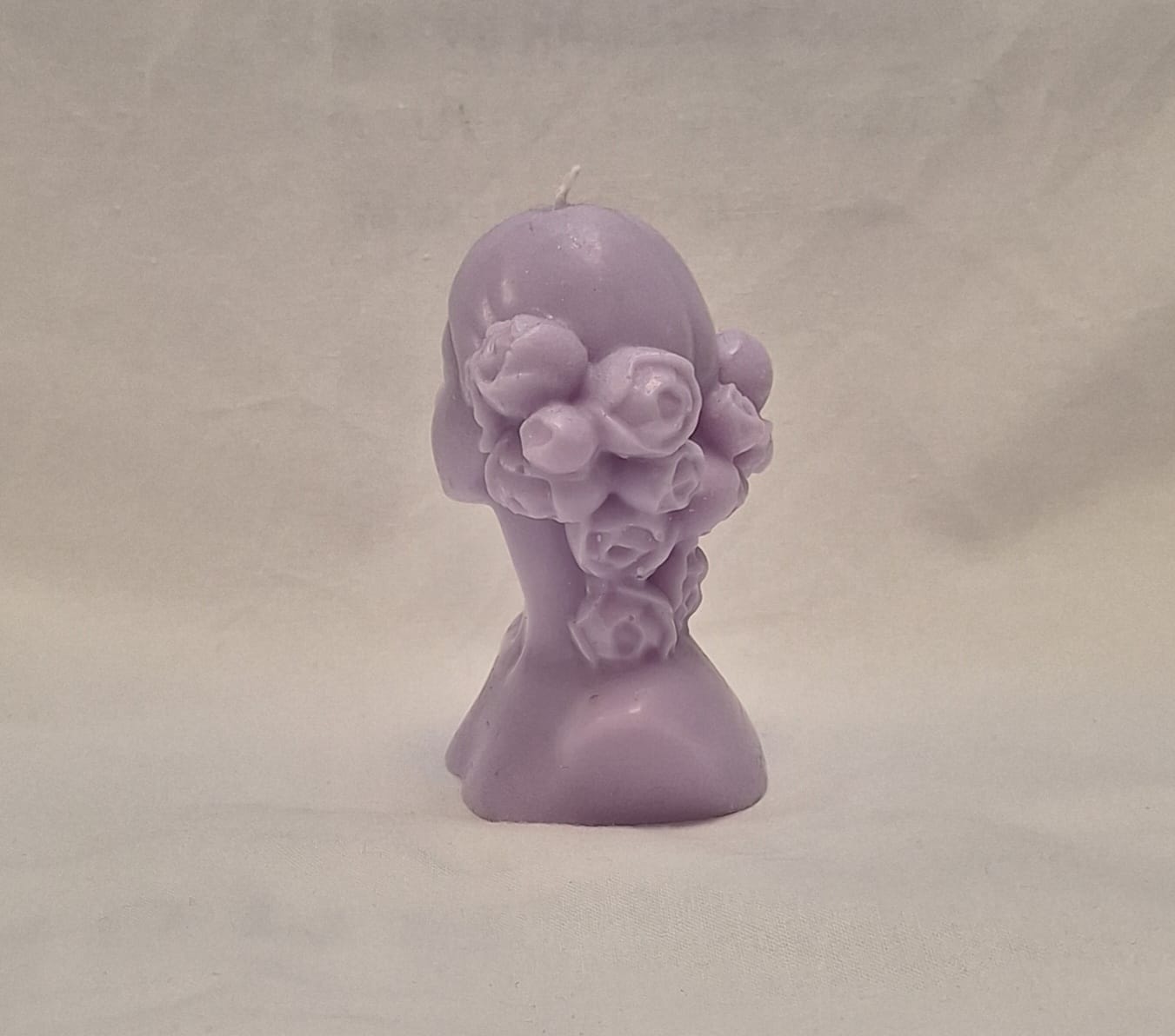 Handmade lavender soy wax girl bust candle with sculpted rose hair detail, perfect for gifts or home decor.